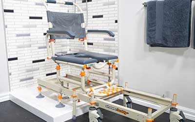 Image of a Showerbuddy chair in a bathroom setting, designed to provide stability and support for individuals during showering.