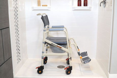 Showerbuddy shower chair with locking wheels, positioned in a white-tiled shower space, designed to provide secure and accessible showering facilities for individuals with limited mobility.