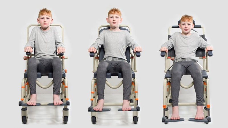 A young boy demonstrating the adjustable features of a Showerbuddy chair, emphasizing the chair's versatility for accommodating younger or smaller users.