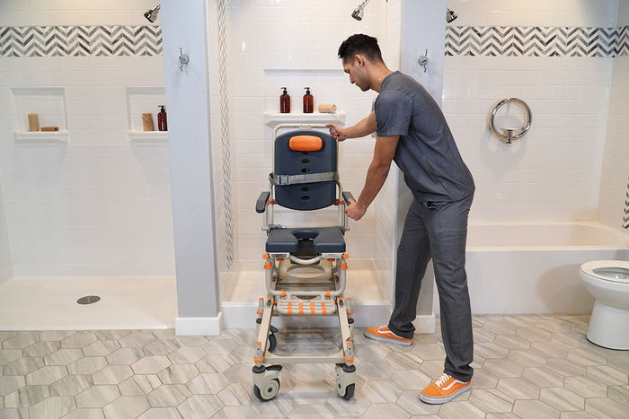 Image of a man in a bathroom adjusting a Showerbuddy chair.