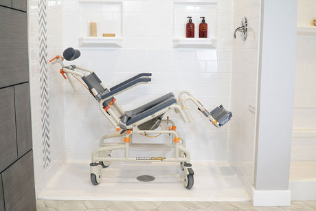 Reclined Showerbuddy chair in a shower stall, highlighting its adjustable positioning and supportive design for a comfortable and accessible showering experience.