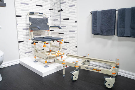 The Showerbuddy roll-in shower chair system set up in a bathroom with a white shower step, showcasing the chair's extended track for easy transfer and accessibility in a shower with modern aesthetics.