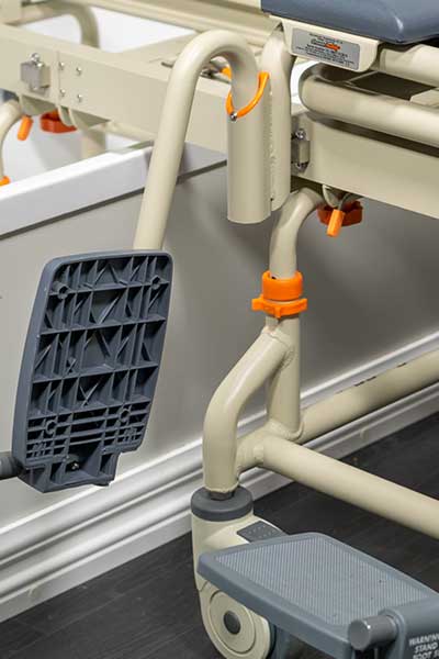 Image showing the adjustable footrest and leg height of a Showerbuddy chair, emphasizing the chair's full adjustability for user comfort.