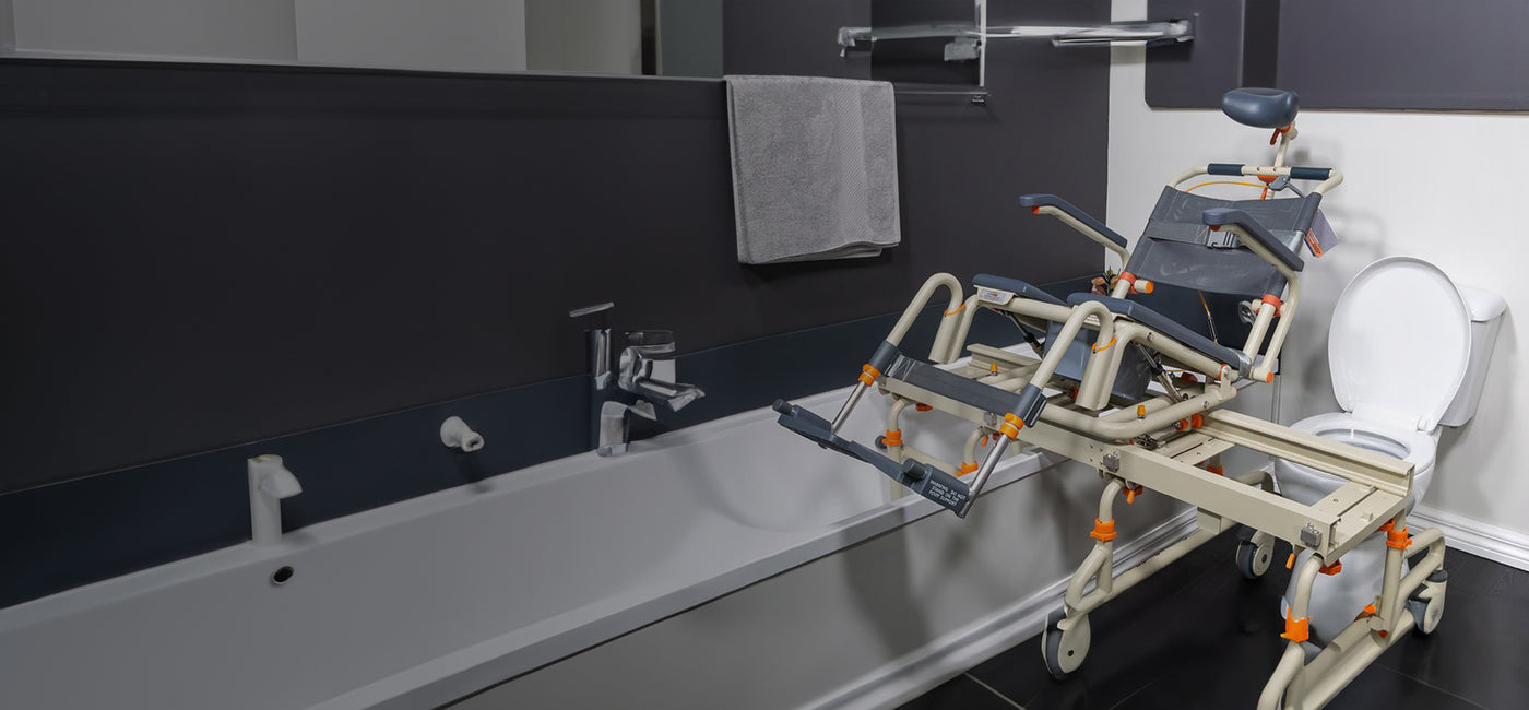 Wide-angle image of a Showerbuddy bath transfer system in a bathroom, emphasizing the safety and ease it provides for individuals with mobility impairments.