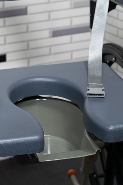 Image showing the cushioned part of a commode chair, focusing on the comfortable seat design for enhanced user comfort.