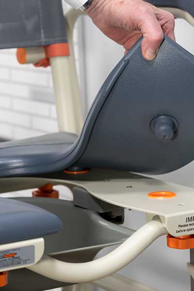 Close-up image of a cushioned seat on a Showerbuddy chair being lifted, demonstrating the high level of comfort provided by the cushioning.
