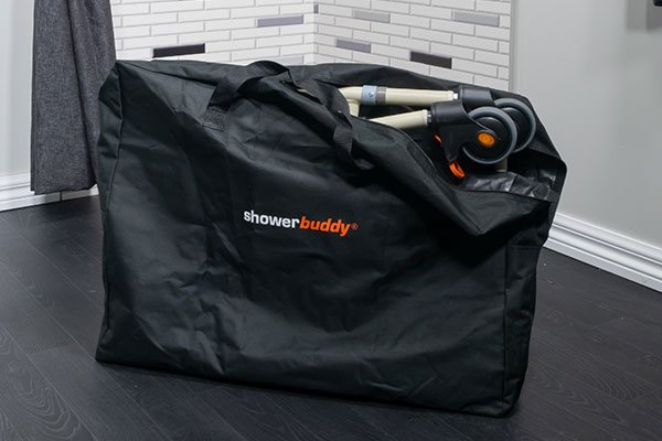 Image of a folded Showerbuddy chair packed in a black travel bag, suggesting its portability and convenience for users on the go.