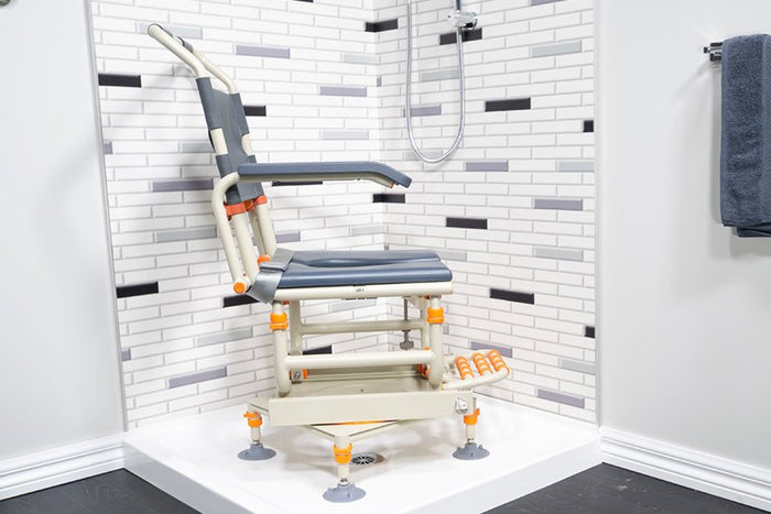Image of a Showerbuddy transfer chair within a shower stall, highlighting the chair's height adjustability for the seat and footrests to facilitate effortless transfers.