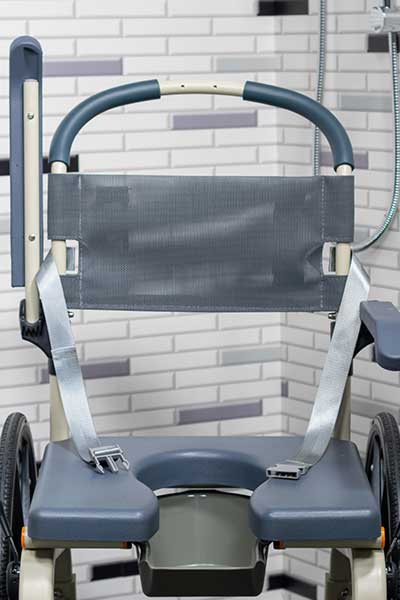 Image focusing on the backrest and safety harness of a Showerbuddy chair, highlighting the features that contribute to safe, comfortable, and relaxing showers.